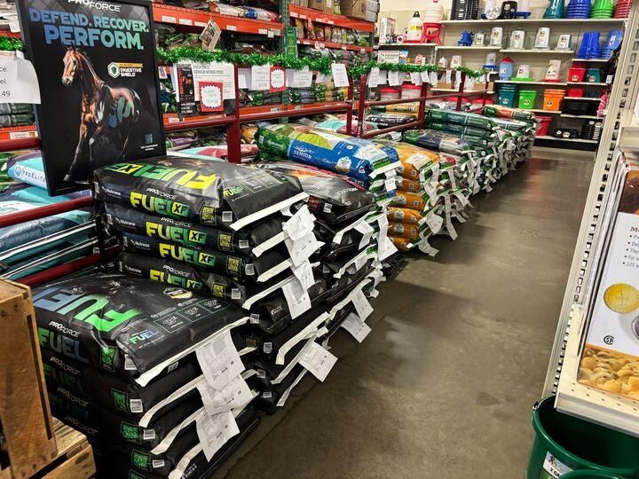 Horse feed bags and equine products displayed at a horse feed store in Visalia.